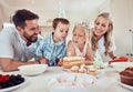 Happy family celebrating daughters birthday. Little girl blowing out candles on her birthday cake. Brother and sister Royalty Free Stock Photo