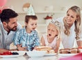 Happy family celebrating daughters birthday. Little girl blowing out candles on her birthday cake. Brother and sister Royalty Free Stock Photo