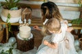 Happy family celebrating first birthday of baby daughter with cake. 1st Birthday home party ideas with natural Royalty Free Stock Photo