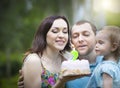 Happy family celebrating second birthday of baby daughter