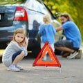 Happy family changing a car wheel Royalty Free Stock Photo