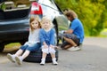 Happy family changing a car wheel Royalty Free Stock Photo