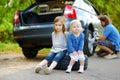 Happy family changing a car wheel Royalty Free Stock Photo