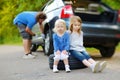 Happy family changing a car wheel Royalty Free Stock Photo