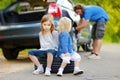 Happy family changing a car wheel Royalty Free Stock Photo