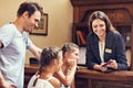 Happy family checking in hotel at reception desk Royalty Free Stock Photo