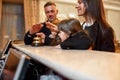 We are here. Happy family checking in hotel at reception desk. A son and a daughter are ringing a service bell together Royalty Free Stock Photo