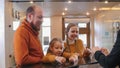 A happy family checking in the hotel - standing by the reception Royalty Free Stock Photo