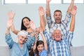 Happy family cheering in the living room Royalty Free Stock Photo