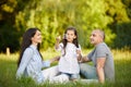 Happy family with child girl blow soap bubbles Royalty Free Stock Photo