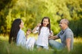 Happy family with child girl blow soap bubbles Royalty Free Stock Photo