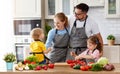 Appy family with child preparing vegetable salad Royalty Free Stock Photo