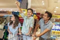 Family with child and shopping cart buying food at grocery store or supermarket Royalty Free Stock Photo