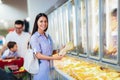 Family with child and shopping cart buying food at grocery store or supermarket Royalty Free Stock Photo