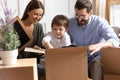 Happy family with child unpack at new home