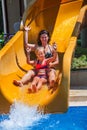 Happy family with child on water slide at aquapark Royalty Free Stock Photo