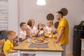 A big family has breakfast together. parents and children in the kitchen. family eats croissants Royalty Free Stock Photo