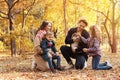 Happy family with children and dog in park. Royalty Free Stock Photo