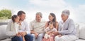 Happy family with children and grandparents talking, communication and conversation on couch outdoor in family home. Big Royalty Free Stock Photo