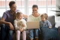 Happy family with children having fun using laptop on sofa Royalty Free Stock Photo