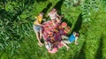 Happy family with children having picnic in park, parents with kids sitting on garden grass and eating healthy meals outdoors Royalty Free Stock Photo