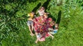 Happy family with children having picnic in park, parents with kids sitting on garden grass and eating healthy meals outdoors Royalty Free Stock Photo