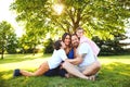 Happy family with children sitting under tree Royalty Free Stock Photo