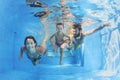 Happy family with children swimming with fun in pool Royalty Free Stock Photo