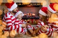 Happy family with children near fireplace at Christmas Royalty Free Stock Photo