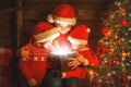 Happy family on Christmas Eve. mother and children discover a ma Royalty Free Stock Photo