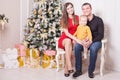 Happy family at Christmas eve sitting together near fireplace Royalty Free Stock Photo