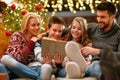 Happy family on Christmas holiday reading book