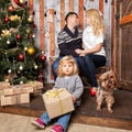 Happy family Christmas. Mother, father, baby and dog Royalty Free Stock Photo