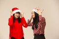 Happy family in Christmas sweater posing on a red background in the studio. Royalty Free Stock Photo