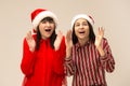 Happy family in Christmas sweater posing on a red background in the studio. Royalty Free Stock Photo