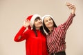 Happy family in Christmas sweater posing on a red background in the studio. Royalty Free Stock Photo