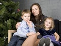 Happy family at christmas tree sitting home smiling, together for holiday, lifestyle people concept Royalty Free Stock Photo