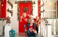 Happy family in Christmas in yard of New Year`s house, tradition celebrating parents with children