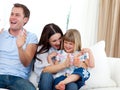 Happy family clapping a goal