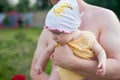 Happy family: a close up portrait of young dad holding his cute newborn baby in summer Royalty Free Stock Photo