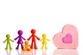 Happy family colored figurines and pink heart on a white background