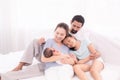 Happy family concept, father and daughter sit on bed excited looking new member in family, adorable newborn sleep on mother chest Royalty Free Stock Photo