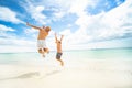 Happy family concept. Father and son jumping at the tropical beach, having fun together. Summer vacation. Happiness. Joy. Fun Royalty Free Stock Photo