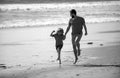 Happy family concept. Father and son running on summer beach. Dad and child playing outdoor. Royalty Free Stock Photo