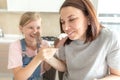 Mother with daughter in kitchen eating ice cream. Good relations of parent and child. Happy family concept Royalty Free Stock Photo