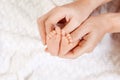 Happy Family concept. Newborn baby feet in mother hands on white background.  Mom holding her Child.  Beautiful conceptual image Royalty Free Stock Photo