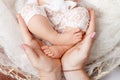 Happy family concept. Newborn baby feet in mother hands in white background.  Mother gently holding legs of a newborn child  in Royalty Free Stock Photo