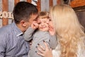 Happy family concept. Parents kissing baby. Royalty Free Stock Photo