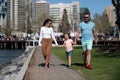 Happy family concept. Parents with son walking in the city. Family taking a walk on street. Young couple walk in city Royalty Free Stock Photo