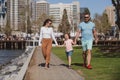 Happy family concept. Parents with son walking in the city. Family taking a walk on street. Young couple walk in city Royalty Free Stock Photo